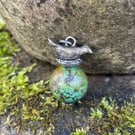 Sterling silver bird in nest and big turquoise bead pendant.