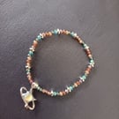 Elasticated multi-coloured beaded bracelet with star charm 