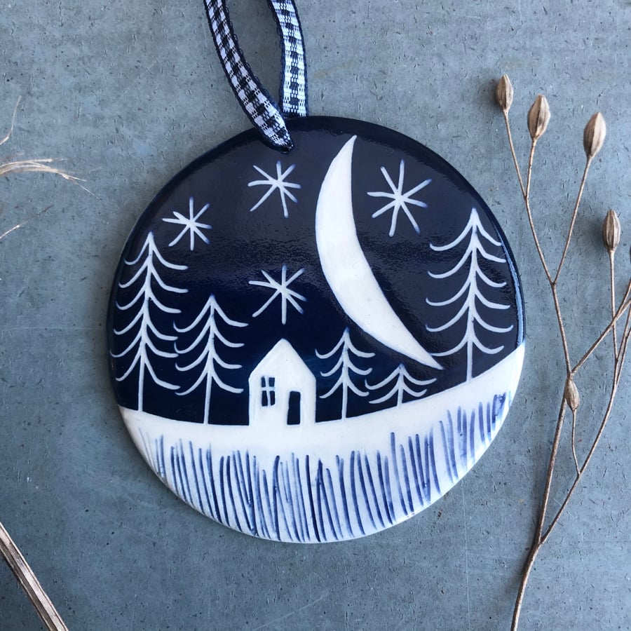 Ceramic Winter scene hanging decoration.