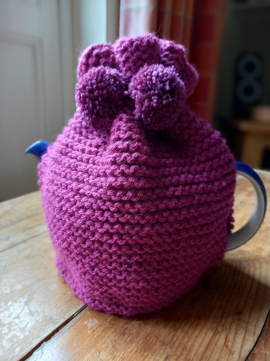 Hand knitted 2 pint (4 pot) tea cosy in Magenta with Plum Pom poms