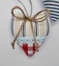 Pair hanging heart decorations on a seaside theme - Image 3