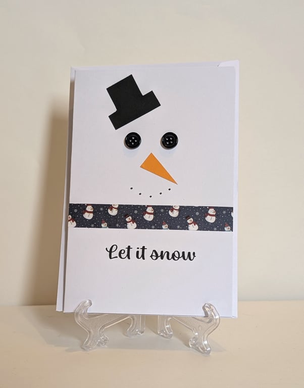 Merry Christmas card with a button eyed snowman saying Let it snow