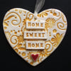 Yellow ceramic heart decoration Home Sweet Home.
