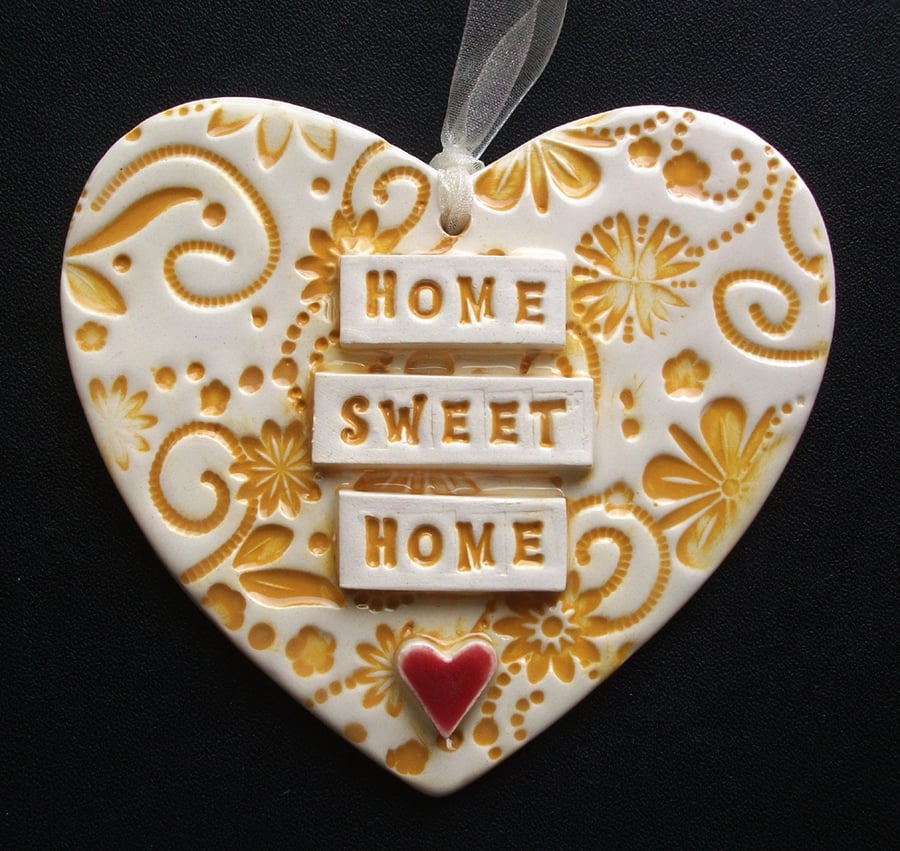 Yellow ceramic heart decoration Home Sweet Home.
