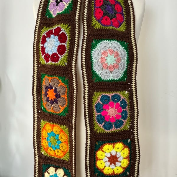 Floral, brown and multicoloured crochet scarf with tassels. Size 74” by 6”.