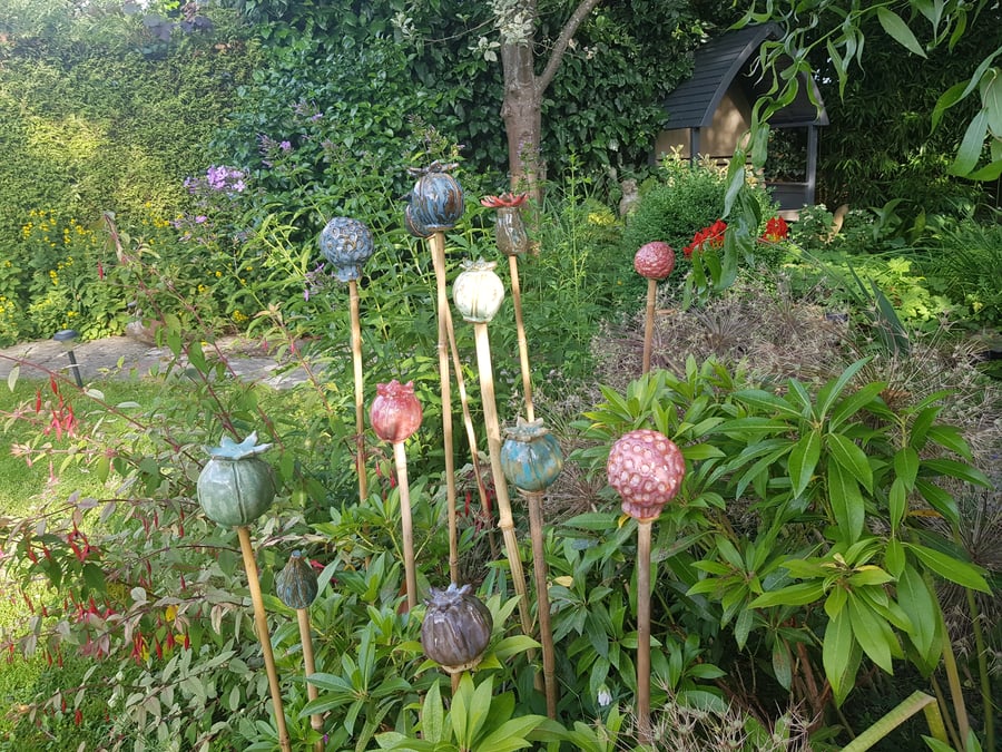 Pottery seed head cane toppers