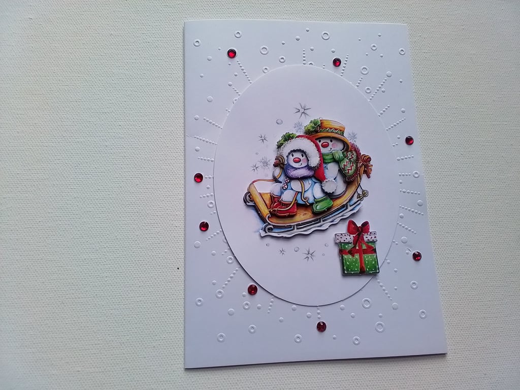 Christmas card. Sledging snowman Christmas card. Ref 235