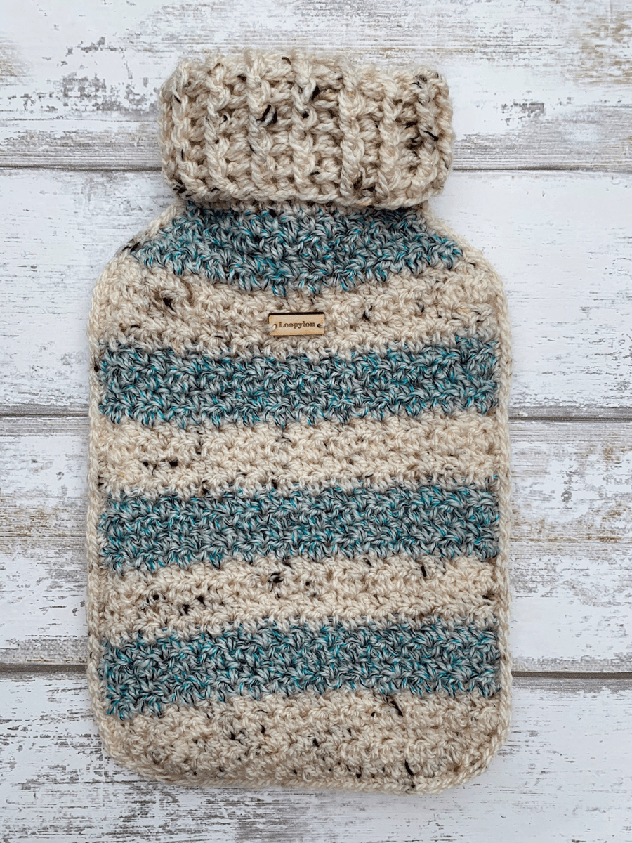 A hot water bottle and handmade crochet cover