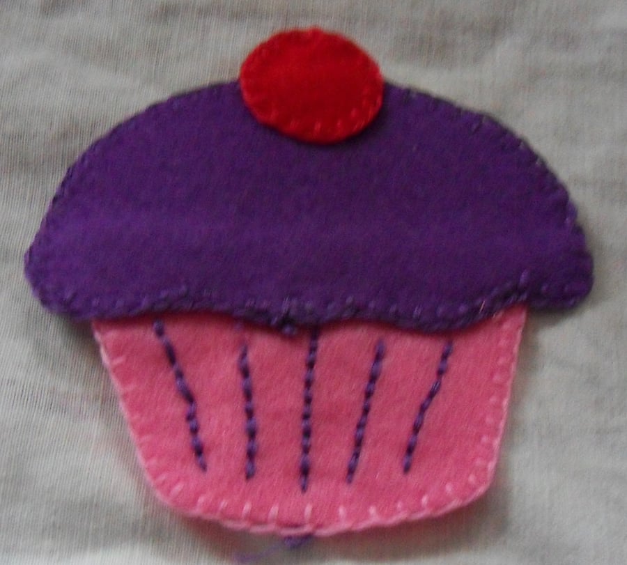 Homemade cup cake embellishment. Purple icing,  Pink cake. Free postage