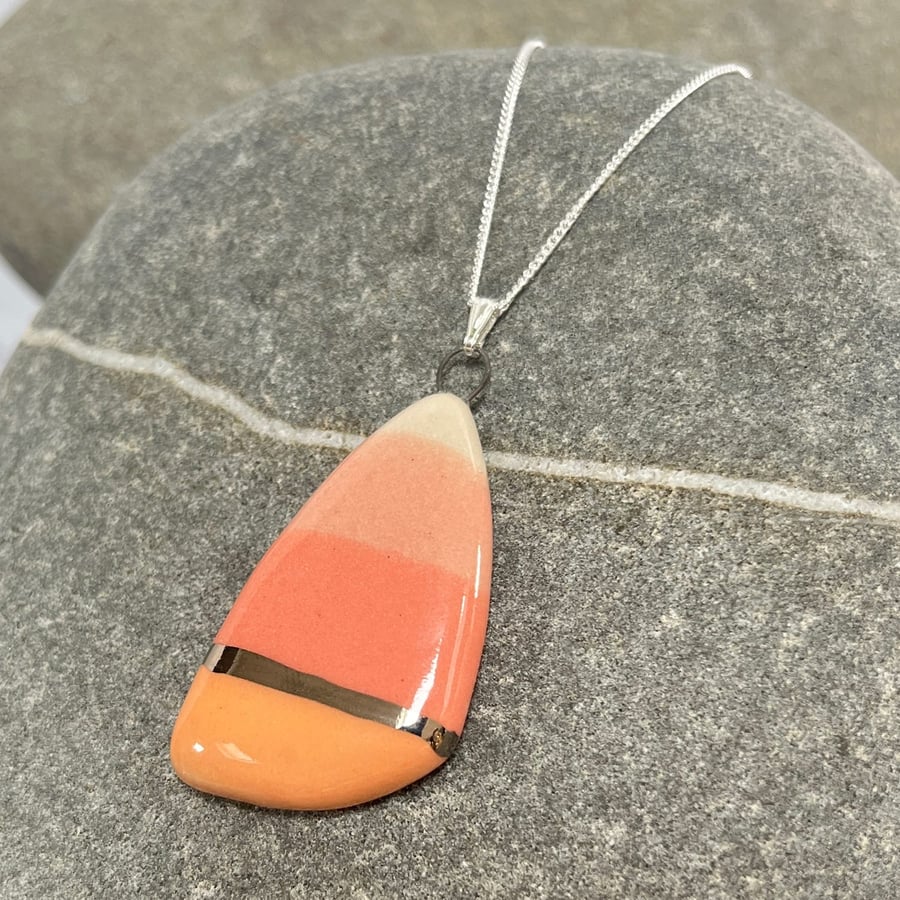 Large pebble shaped pendant in coral and peach with Platinum detail on Sterling 