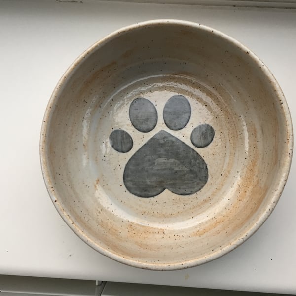 Dog feeding bowl - rustic looking bowl with paw print and bones.