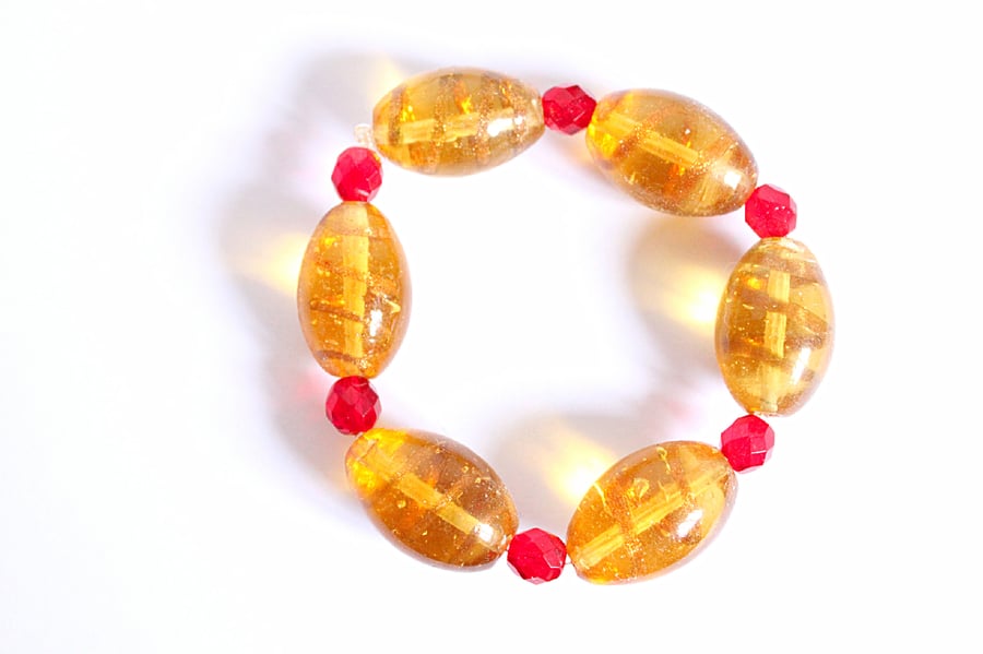 Yellow lampwork bead and red faceted bead elasticated stacking bracelet