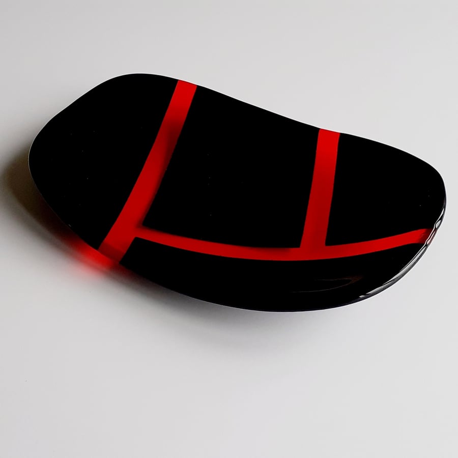 Fused glass decorative dish, glossy black and transparent orange