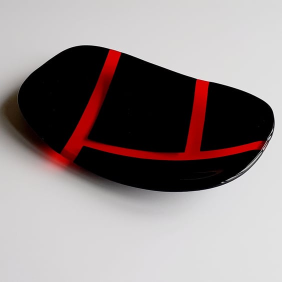 Fused glass decorative dish, black and transparent orange patchwork design