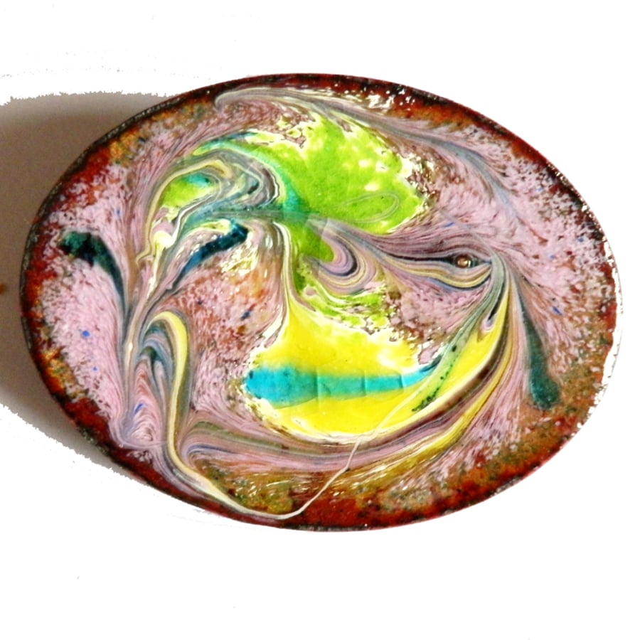 oval brooch, pink enamel with green, yellow, turquoise and white scrolling