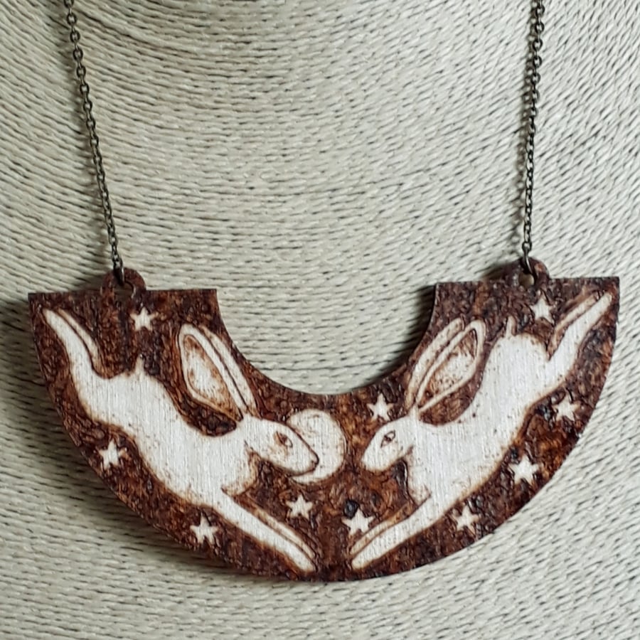 Pyrography leaping hares pendant