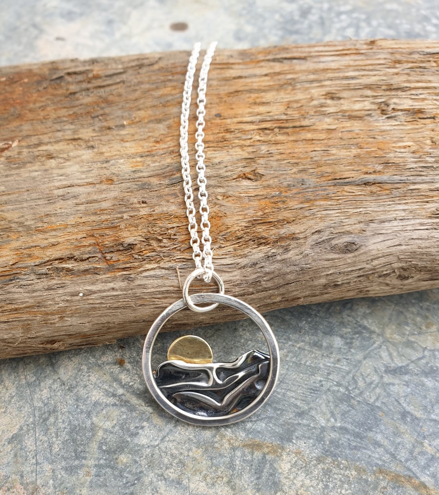 Silver sun rising over sea pendant