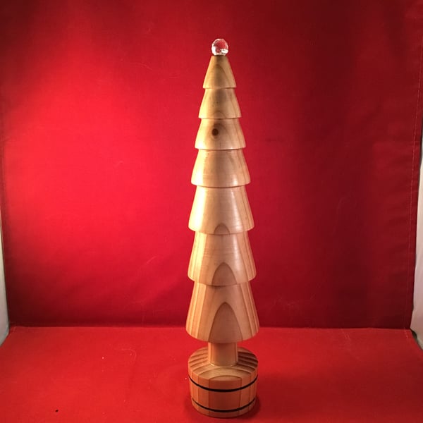 Tall, crystal topped Christmas tree.