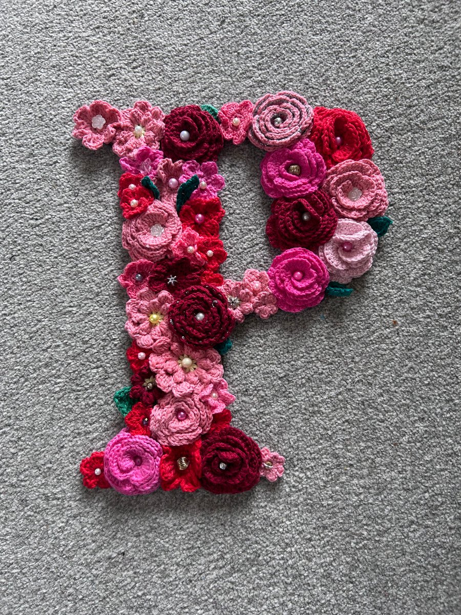 Initial P - crocheted flowers on a plywood backboard
