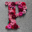 Initial P - crocheted flowers on a plywood backboard