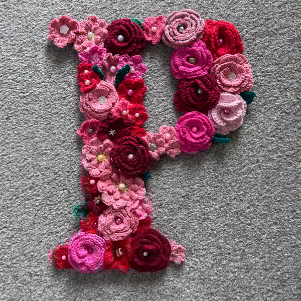Initial P - crocheted flowers on a plywood backboard