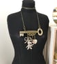 Up-cycled vintage key featured with teddy bear and up-cycled bow charms bracelet