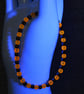 UV Reactive Orange Glass and Dark Metal Bead Elastic Bracelet - Image 3