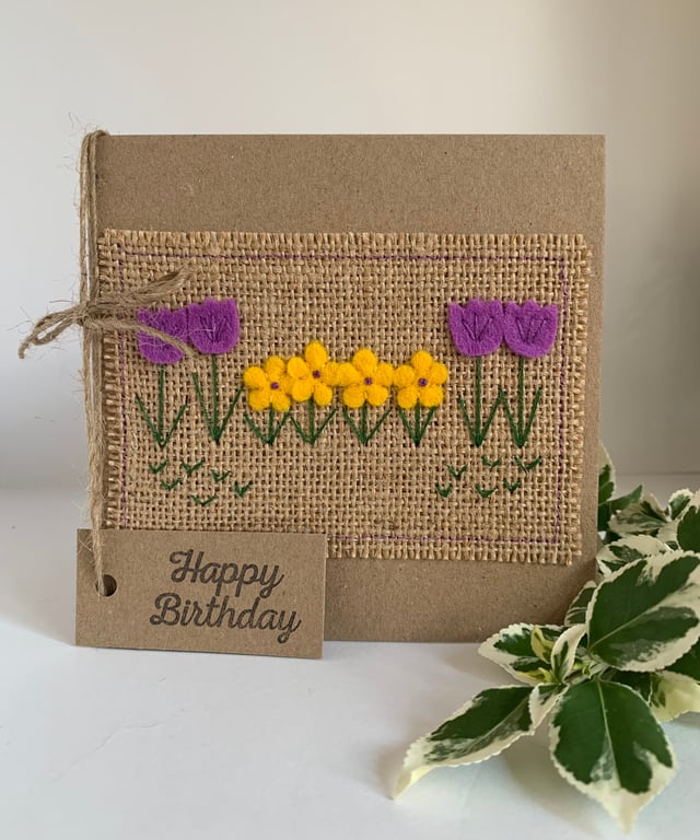 Handmade birthday card. Row of pretty purple and yellow flowers from wool felt.
