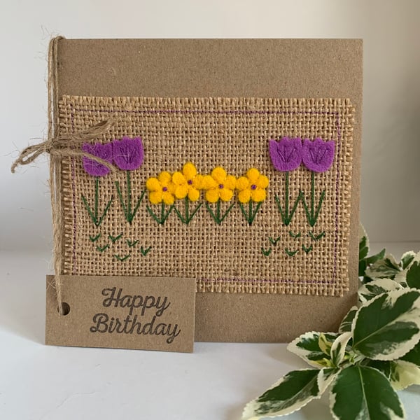 Handmade birthday card. Row of pretty purple and yellow flowers from wool felt.