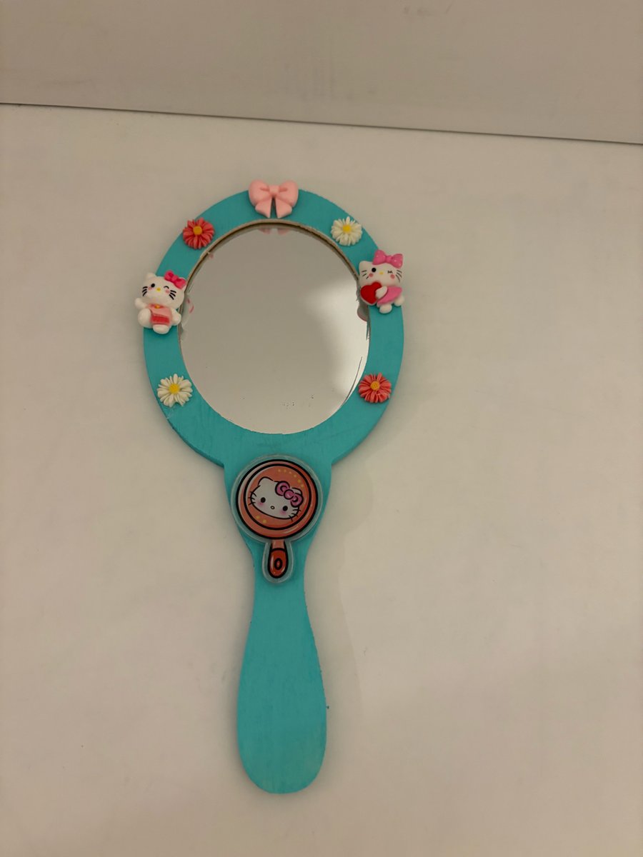 Hand held hand decorated wood mirror. 