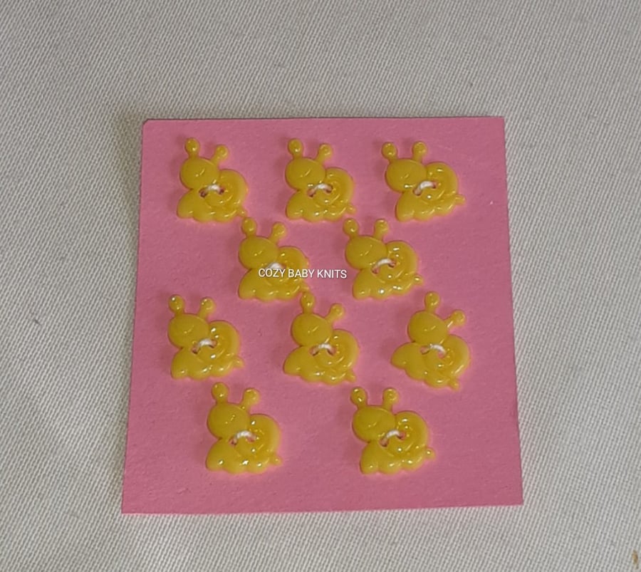 YELLOW SNAIL SHAPE BUTTONS WITH TWO HOLES FOR ATTACHING 