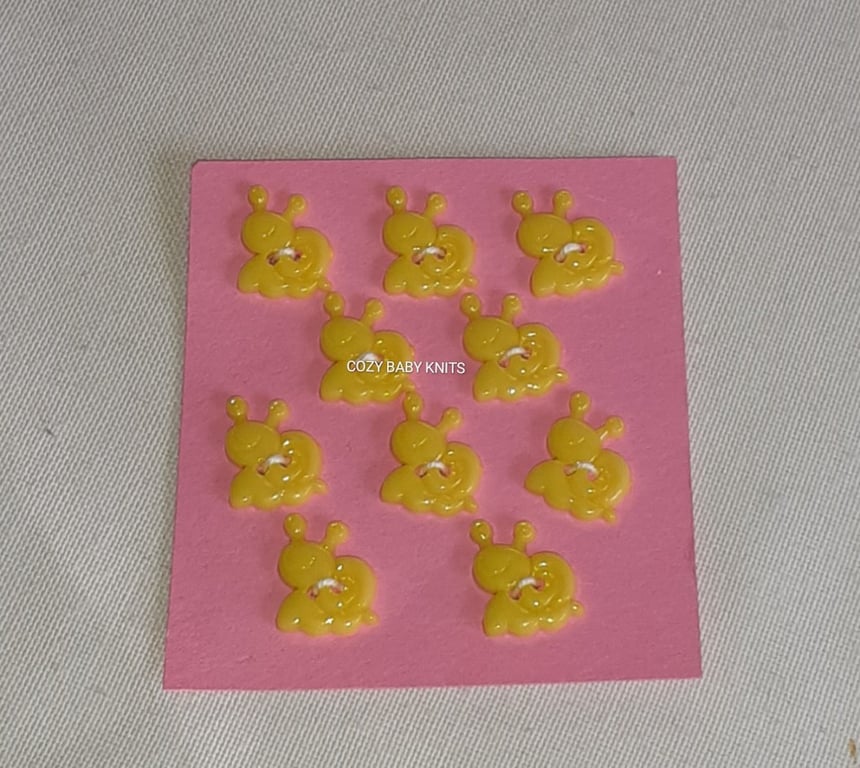YELLOW SNAIL SHAPE BUTTONS WITH TWO HOLES FOR ATTACHING 