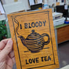 I bloody love tea. Orange and black print. Size A5.