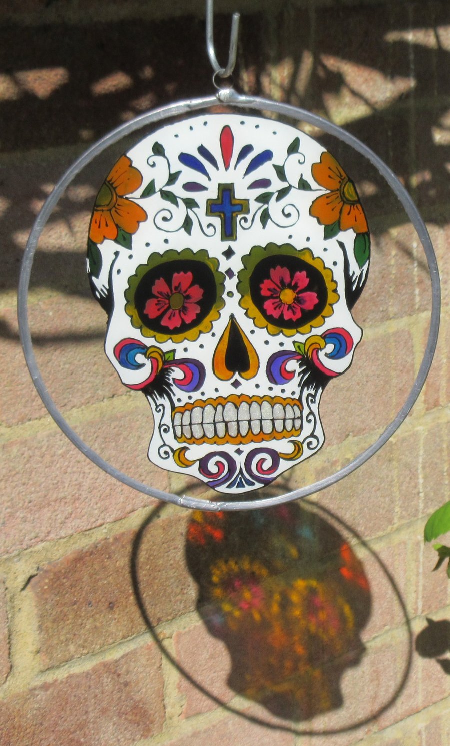 SOLD Suncatcher - Day of the Dead Skull with pink eyes and cross