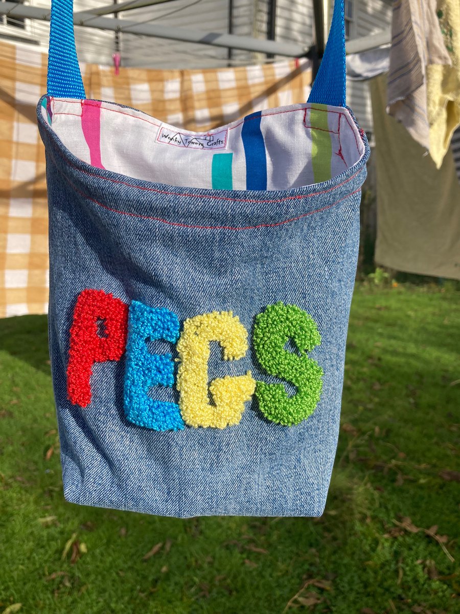 Recycled denim peg bag with blue shoulder strap and embroidered decoration 
