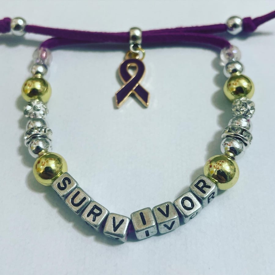 Domestic violence awareness ribbon charm bracelet suede effect corded purple 