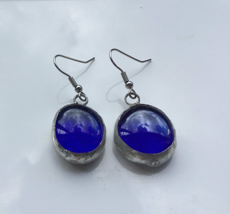 Royal blue, round, glass, drop style, vibrant and different earrings.
