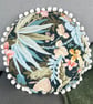 Round feature cushion in vintage leafy linen with pompoms - Image 5