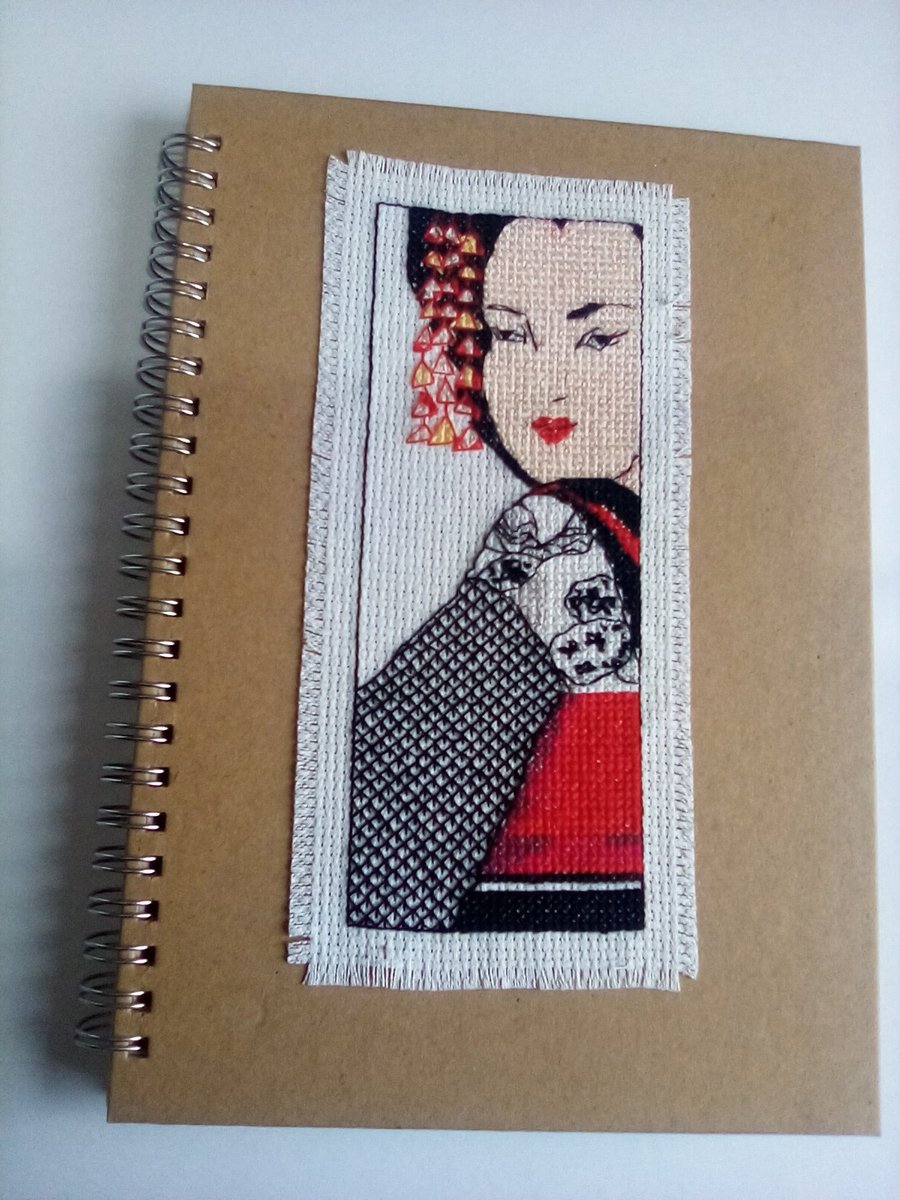 Beautiful hand stitched cross stitch A5 spiral bound ruled hard backed notebook.