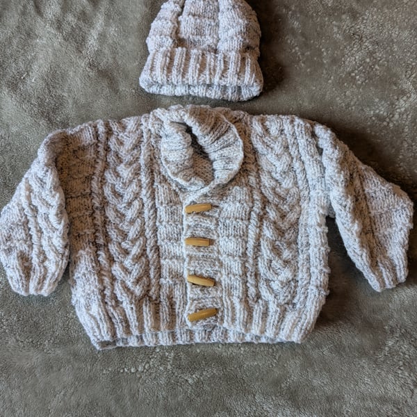 Baby's scarf neck cable cardigan with matching hat 