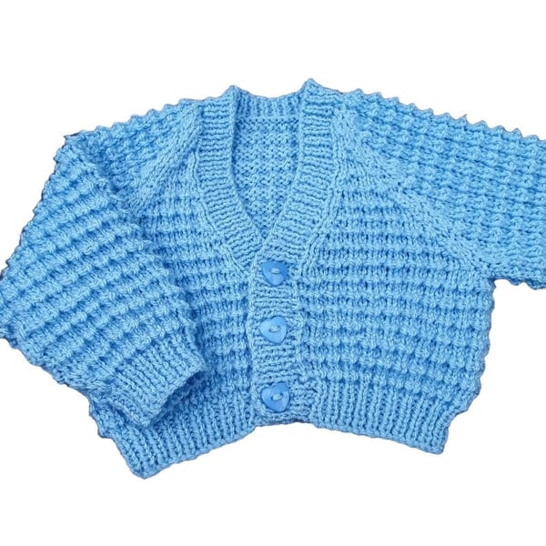Hand knitted baby cardigan in baby blue, textured pattern  