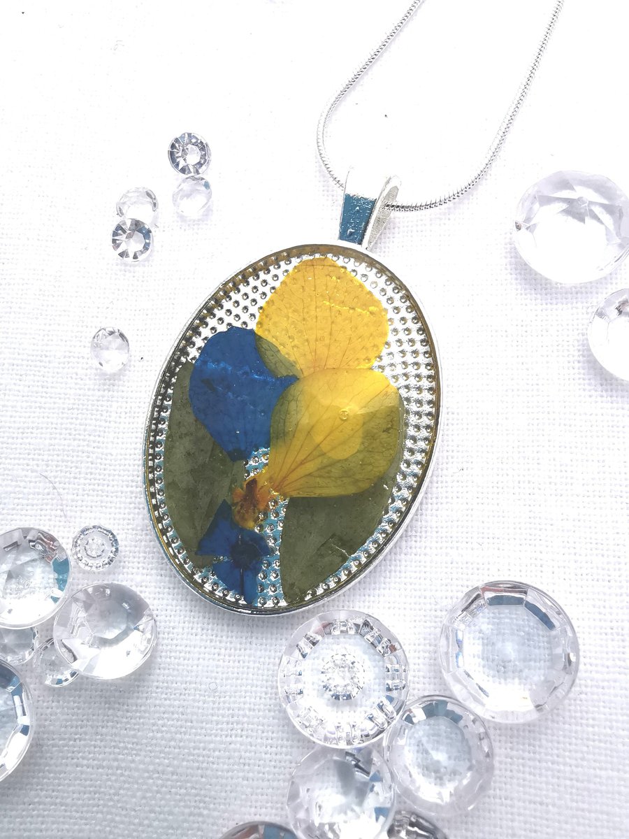Medium Oval Resin Pendant With Blue and Yellow Flower Petals