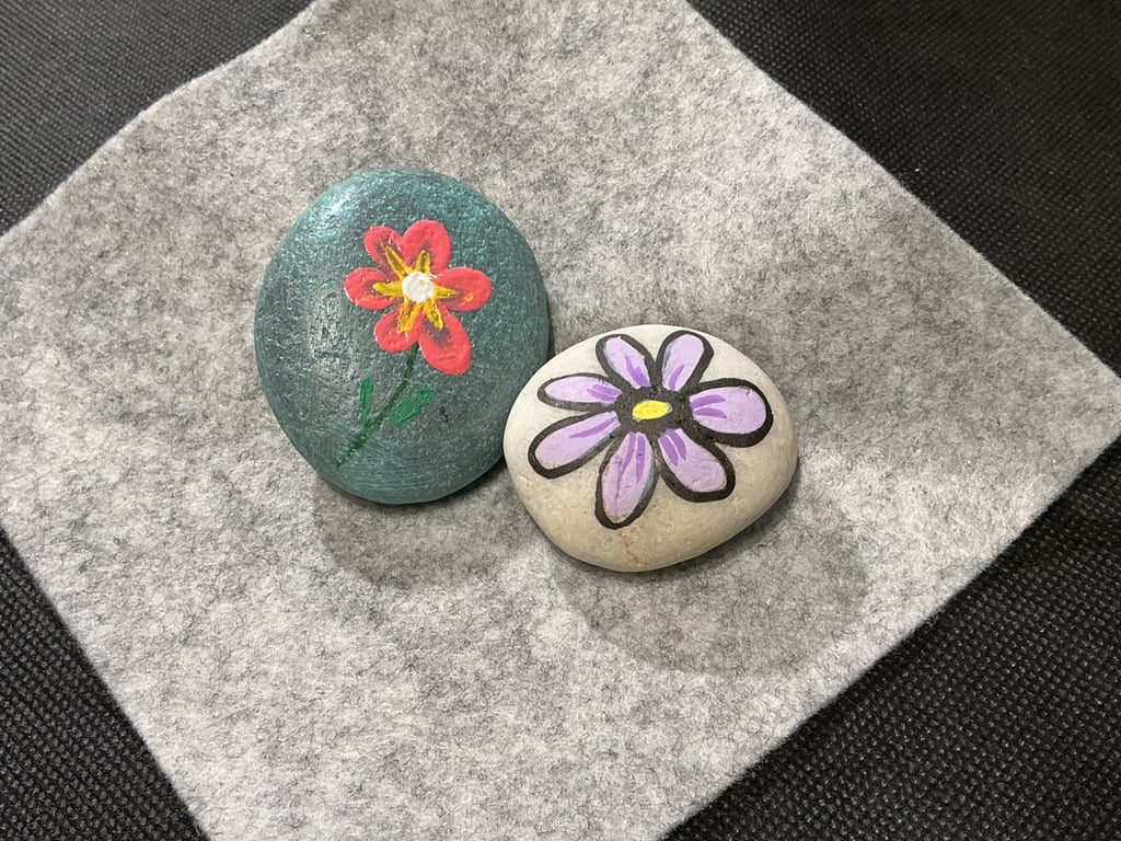 Set of 2 hand painted pebbles with floral theme.