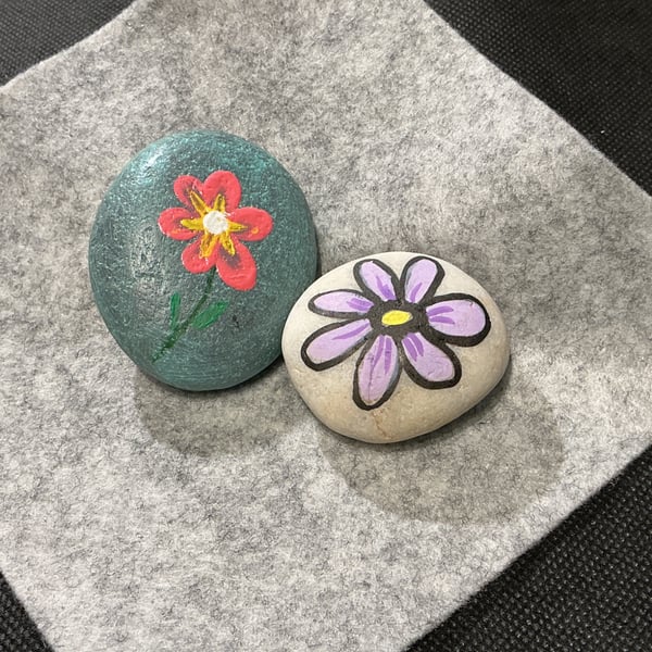Set of 2 hand painted pebbles with floral theme.