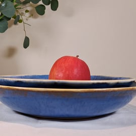 BLUE CERAMIC SERVING BOWLS - a set of two glazed in blue, white rim