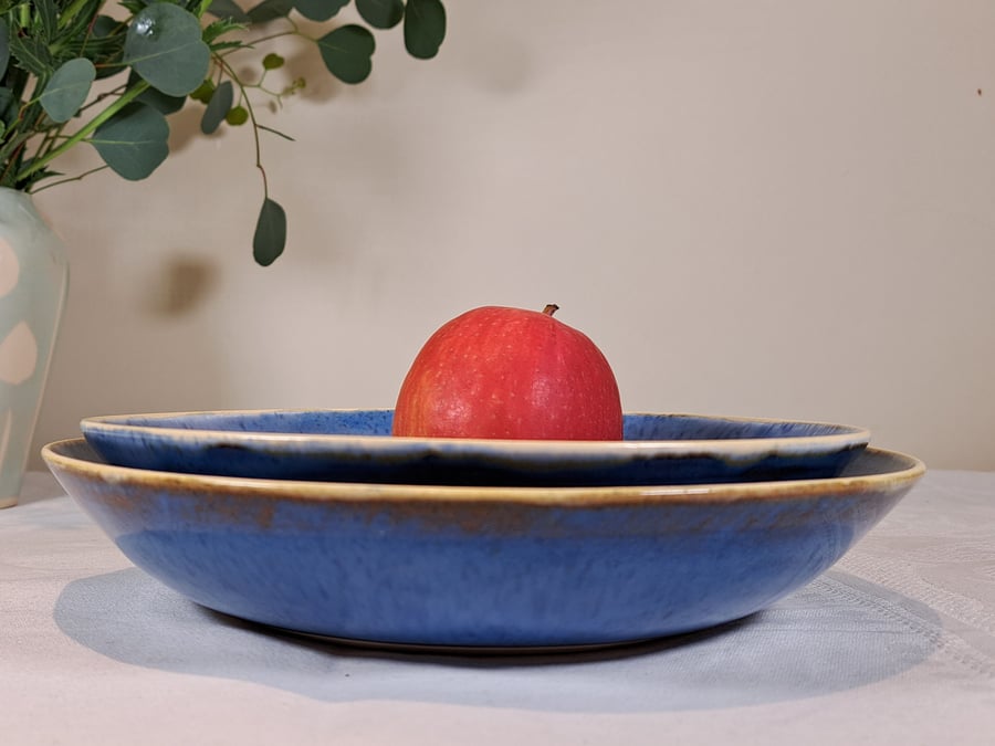 BLUE CERAMIC SERVING BOWLS - a set of two glazed in blue, white rim