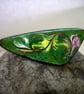 brooch: triangular - scrolled pink, yellow, brown and white on green enamel