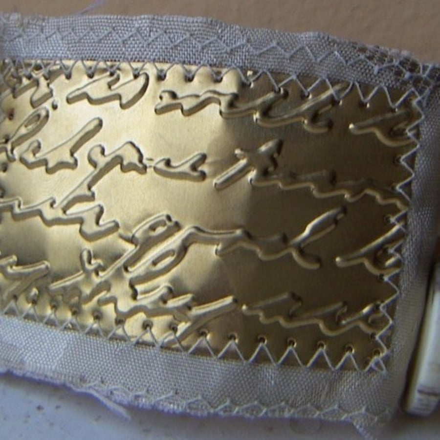 Victoriana sewn metal wristlet - brass love letter on cream damask