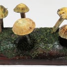 Pretty mushroom log made from re-cycled wood with driftwood and limpet shells