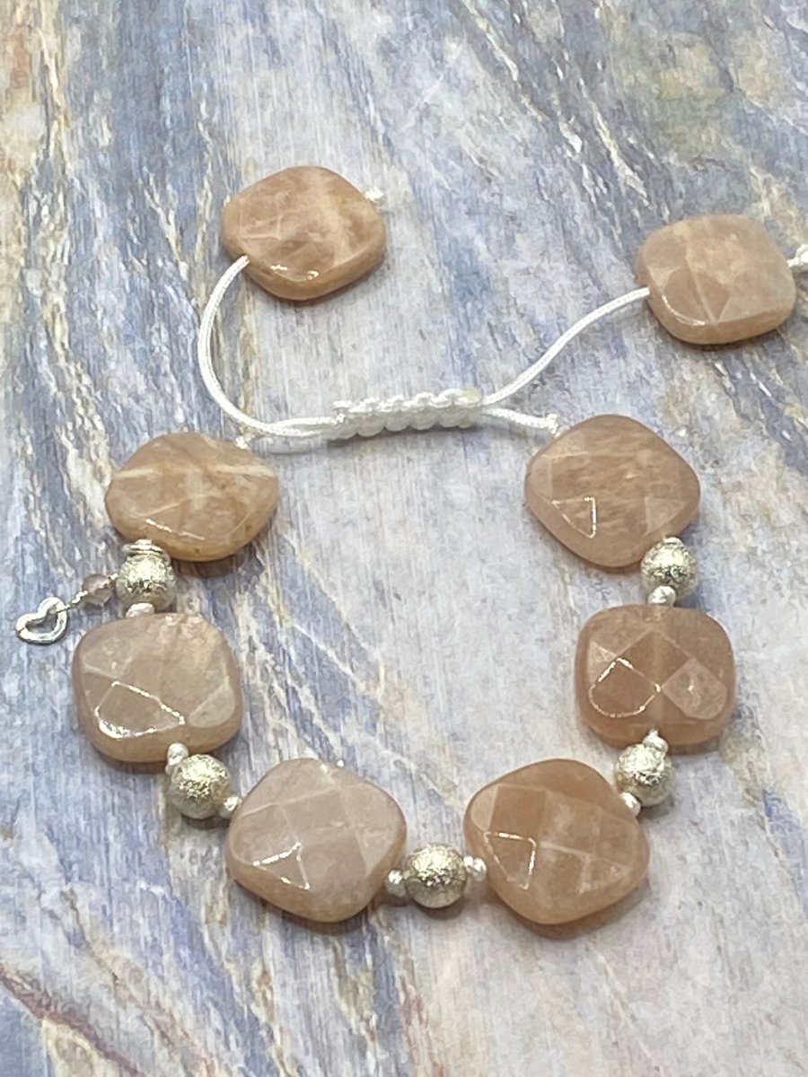 Knotted macrame cord bracelet with peach sunstone squares